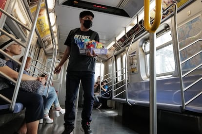 A teenager sells candy and other items in a New York City subway car on August 18, 2023 in New York City. Over 70,000 asylum-seekers have arrived in New York City since last year, according to City Hall, and many have taken to selling items on the streets and subways of the city