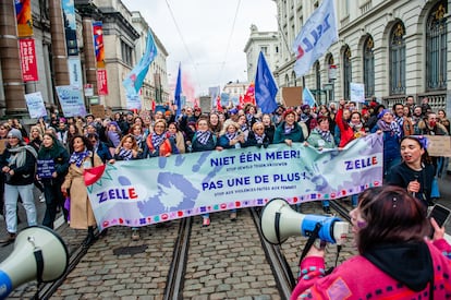 Protesters are seen holding a banner against violence against women during the demonstration