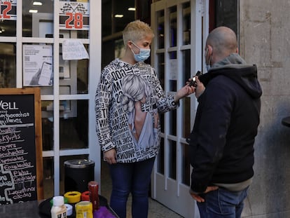 A worker checks a Covid pass in Barcelona.