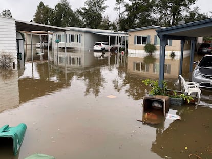 In this photo provided by Juan Reyes, homes are surrounded by floodwaters at the Arbor Mobile Home Park where he lives in Acampo, Calif., Sunday, Jan. 15, 2023.