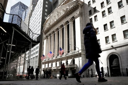 FILE PHOTO: People are seen on Wall Street outside the NYSE in New York, U.S.