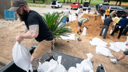 People bag sand in preparation for possible flooding as Tropical Storm Helene heads toward the state's Gulf Coast on September 25, 2024 in Tallahassee, Florida. 