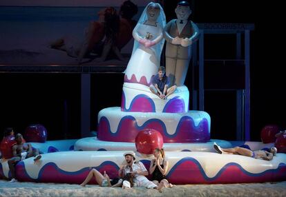 Nemorino (Juan Francisco Gatell, arriba) y Belcore (Alessandro Luogo, abajo en el centro), los rivales por el amor de Adina, en la gran tarta de bodas hinchable del segundo acto de la producción de Damiano Michieletto.