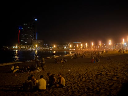 Jóvenes de botellón en la playa de la Barceloneta, el viernes por la noche.