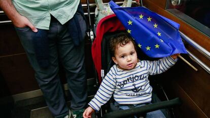 Un niño sostiene una bandera de Europa en una visita al Parlamento de Bruselas.