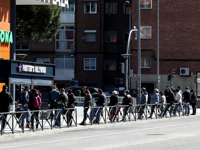 Colas a la entrada de un supermercado en Madrid este sábado.