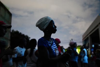 A woman waits to receive her monthly food rations, in a small state-run mark in Santiago, Cuba on March 20.