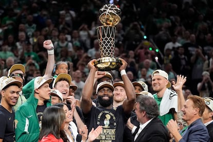 Jaylen Brown with last season's championship trophy.