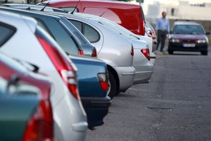 Fila de coches estacionados en una calle de Madrid.