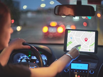 A driver using a navigation system in her car.