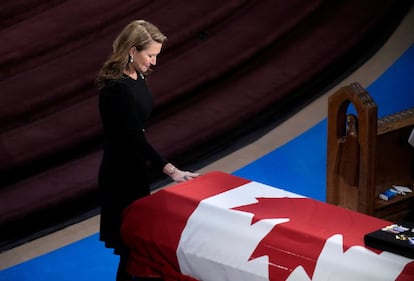 Caroline Mulroney places her hand on her father's casket during the funeral of late former Canadian Prime Minister Brian Mulroney, in Montreal, Canada, Saturday, March 23, 2024.