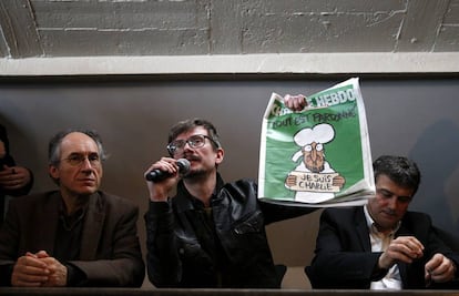 Gérard Biard, Luz and Patrick Pelloux, with the front cover of the edition of Charlie Hebdo published straight after the attack.