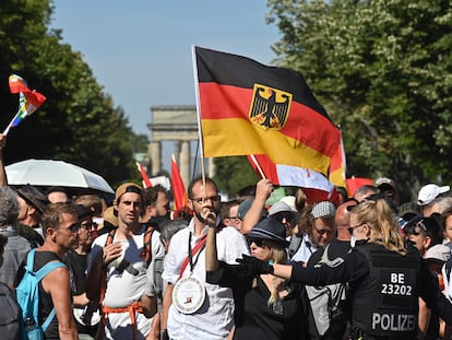 Policial se dirige aos manifestantes em Berlim neste sábado, que reuniu 15.000 pessoas.