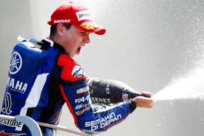 Lorenzo lets out some fizz to celebrate his Italian GP victory.