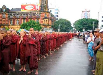 Monjes budistas marchan ayer en Rangún arropados por odecenas de ciudadanos.