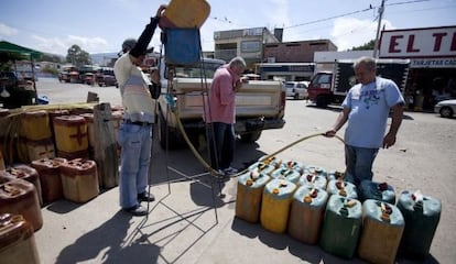 Smugglers filling up gasoline tanks on the Colombian side of the border with Venezuela in 2009.