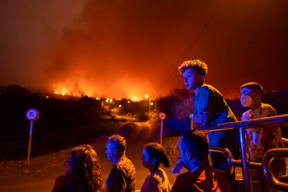 Local residents try to reach their houses in Benijos village as police block the area as fire advances in La Orotava in Tenerife, Canary Islands, Spain on Aug. 19, 2023.