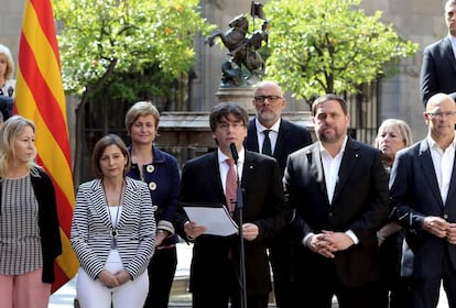 Catalan premier Puigdemont (c) announces referendum date.