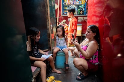 Una mujer grababa el viernes a su hija completando un ejercicio de lectura fuera de su casa en Manila. 