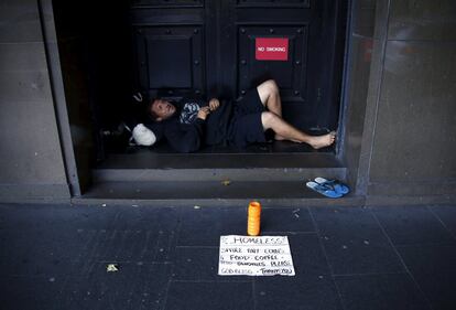 A man claiming he is homeless begs for money as he lies in the emergency exit doorway of a building in central Sydney, Australia, March 5, 2016. REUTERS/David Gray TPX IMAGES OF THE DAY     