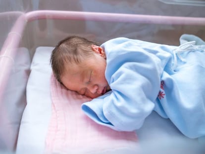 A newborn in his hospital cradle.