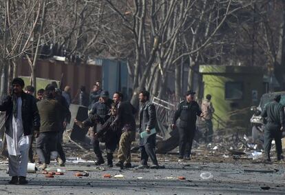 Varias personas trasladan a un herido tras el atentado terrorista en la capital afgana, el 27 de enero de 2018.