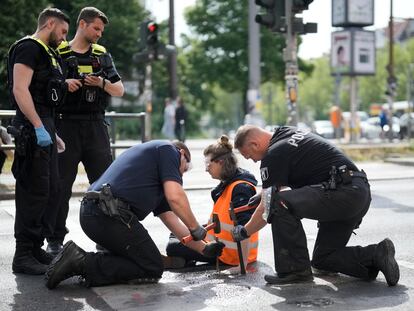 Police officers use hammers and chisels to remove a climate activist who has glued himself to a road during a climate protest in Berlin, Germany, on May 22, 2023. 

Associated Press/LaPresse
Only Italy and Spain