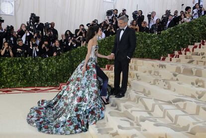 Amal Clooney chegou junto com o marido, George Clooney, desfilando com um ousado look floral metálico com calça.