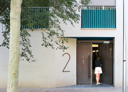 Lorena Cano entra por la puerta principal de LaScala, el edificio de vivienda social en el distrito de Puente de Vallecas (Madrid), el pasado 9 de julio.