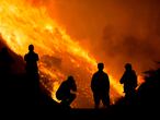 FILE PHOTO: Residents are silhouetted as they watch the Blue Ridge Fire burning in Yorba Linda, California, U.S. October 26, 2020. REUTERS/Ringo Chiu/File Photo