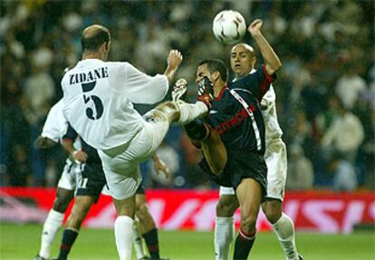 Zidane y Ángel se muestran las plantillas en su pugna por un balón, ayer en el Bernabéu.