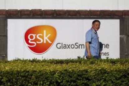 Un guardia de seguridad pasa junto al cartel de la farmacéutica británica GlaxoSmithKline (GSK), en la sede de la empresa en Shanghái, China. EFE/Archivo