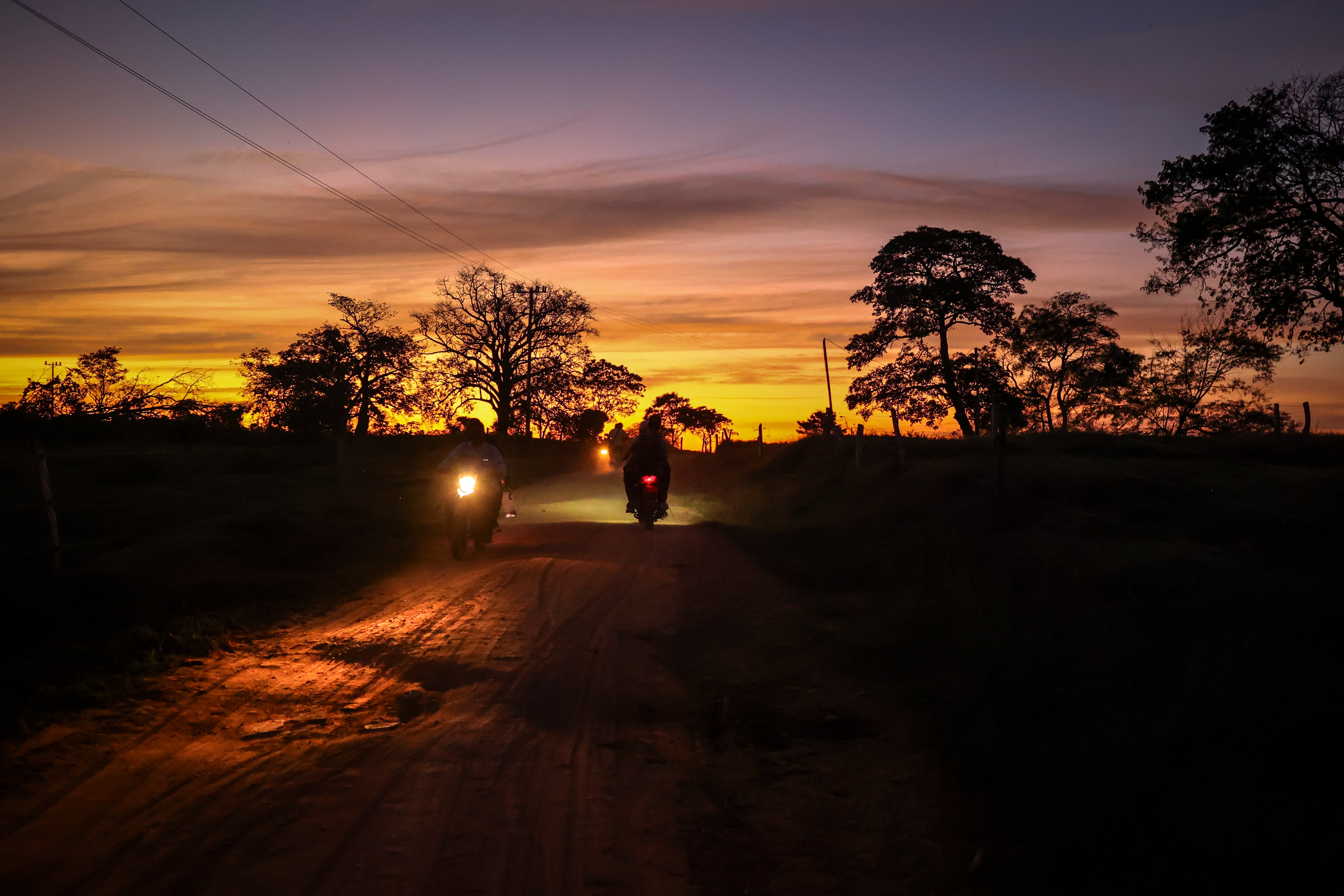 Varios campesinos viajan en moto por una carretera que conecta la casona principal y la entrada de La América.