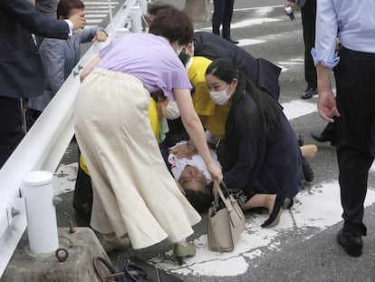 Former Japanese PM Shinzo Abe lies on the ground after apparent gunshots at a campaign rally.