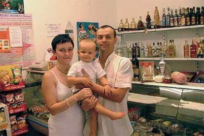 Victoria Plugaru, su marido Alexandru Plamadeala y su hijo, en la tienda de productos rusos Maxim, en Granada.