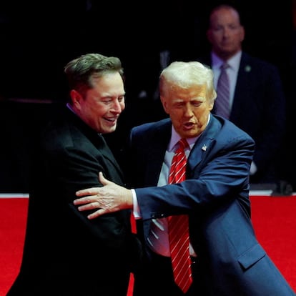 FILE PHOTO: U.S. President-elect Donald Trump greets Tesla CEO and X owner Elon Musk during a rally the day before Trump is scheduled to be inaugurated for a second term, in Washington, U.S., January 19, 2025. REUTERS/Brian Snyder/File Photo