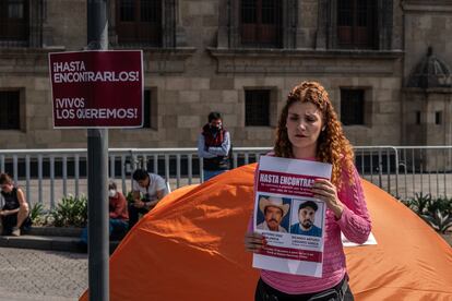 Una mujer sostiene un cartel con la imagen de los activistas desaparecidos Antonio Díaz y Ricardo Lagunes, durante una manifestación en Ciudad de México