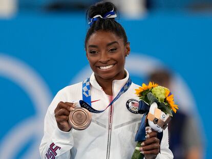 U.S. gymnast Simone Biles poses with her bronze medal for the artistic gymnastics women's balance beam apparatus at the 2020 Summer Olympics, on Aug. 3, 2021, in Tokyo, Japan.