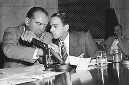 El senador Joseph McCarthy tapa el micrófono para consultar a su asesor legal, Roy Cohn, durante una de las sesiones públicas celebradas en abril de 1954.