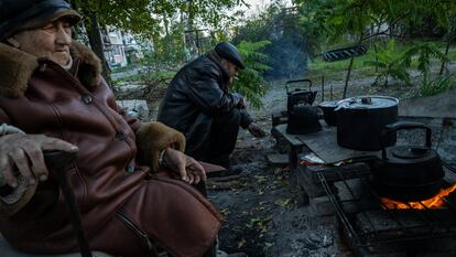 Dos personas se preparaban para el invierno en Lyman, cerca del frente.