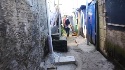 Vaninha, moradora da Vila Nova Esperança, caminha entre as ruas da favela para chegar até sua casa.