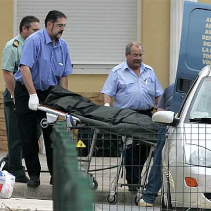 Los servicios funerarios trasladan el cuerpo de una de las víctimas del doble crimen en Càlig.