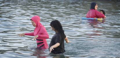 Women bathe while clothed on Monday at the beach in Montgat, Barcelona.