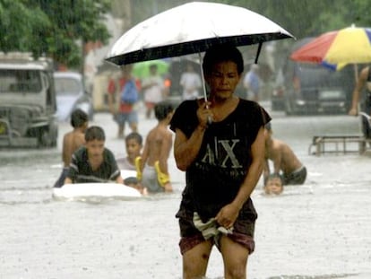 Un hombre camina en una calle de Manila, tras el monz&oacute;n de 2002. 