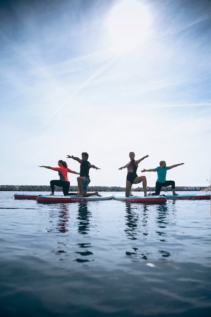 Practicantes en Barcelona de paddle yoga, una de las novedosas variantes yoga que se están popularizando.