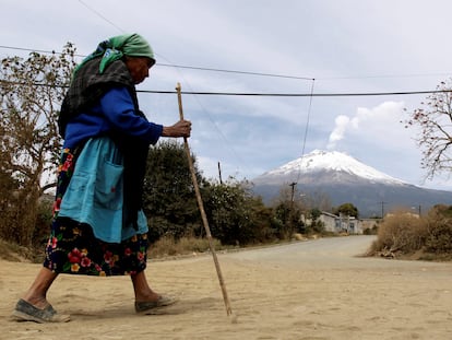 A local resident walks as the Popocatepetl volcano belches a column of steam in Xalitzintla, in the state of Puebla, located 125 km east of Mexico City, February 1, 2012. Civil protection officials from the Puebla government are giving evacuation training to residents of this village located 12 km from the Popocatepetl volcano, ahead of a possible eruption, after an increase of volcanic activity and ash eruptions have been registered recently.   REUTERS/Henry Romero REFILE - REMOVING LOCATION CLASSIFICATION