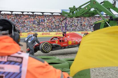 Una grúa retira el monoplaza de Sebastian Vettel después de un golpe.