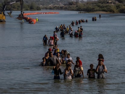 A group of migrants crosses the Rio Grande near Eagle Pass in Texas.