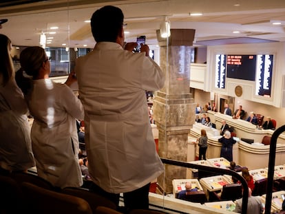 Doctors from the Alabama Fertility Clinic takes photos of the votes as the debate over SB159 bill (IVF Fertility Bill) in the House Chambers is voted on, Wednesday, March 6, 2024, in Montgomery, Ala.