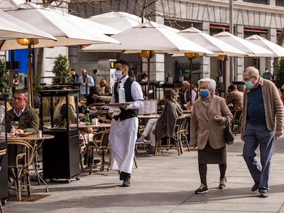 Un camarero atiende la terraza de un bar en la Puerta de Alcalá, en Madrid, el 13 de marzo.